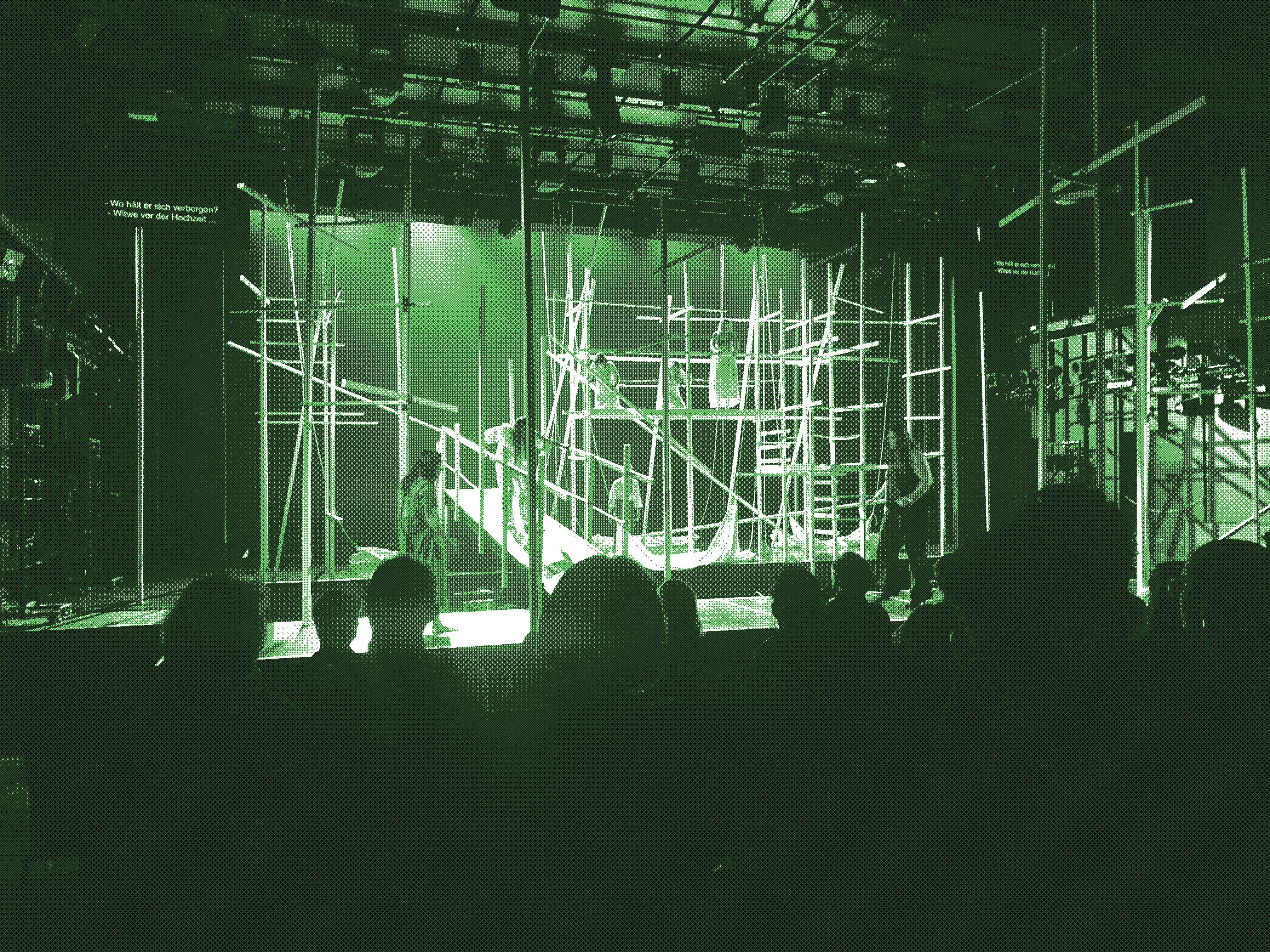 The opera stage set with masts everywhere, a bridge and singers
