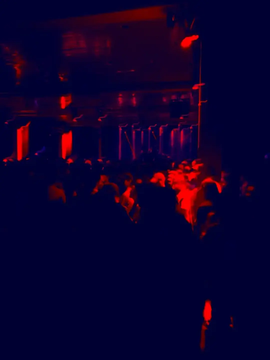 crowd of people in dark room, blurry