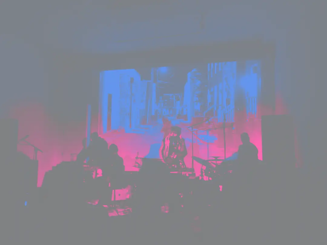 Konjur Collective quartet performing in front of a projection