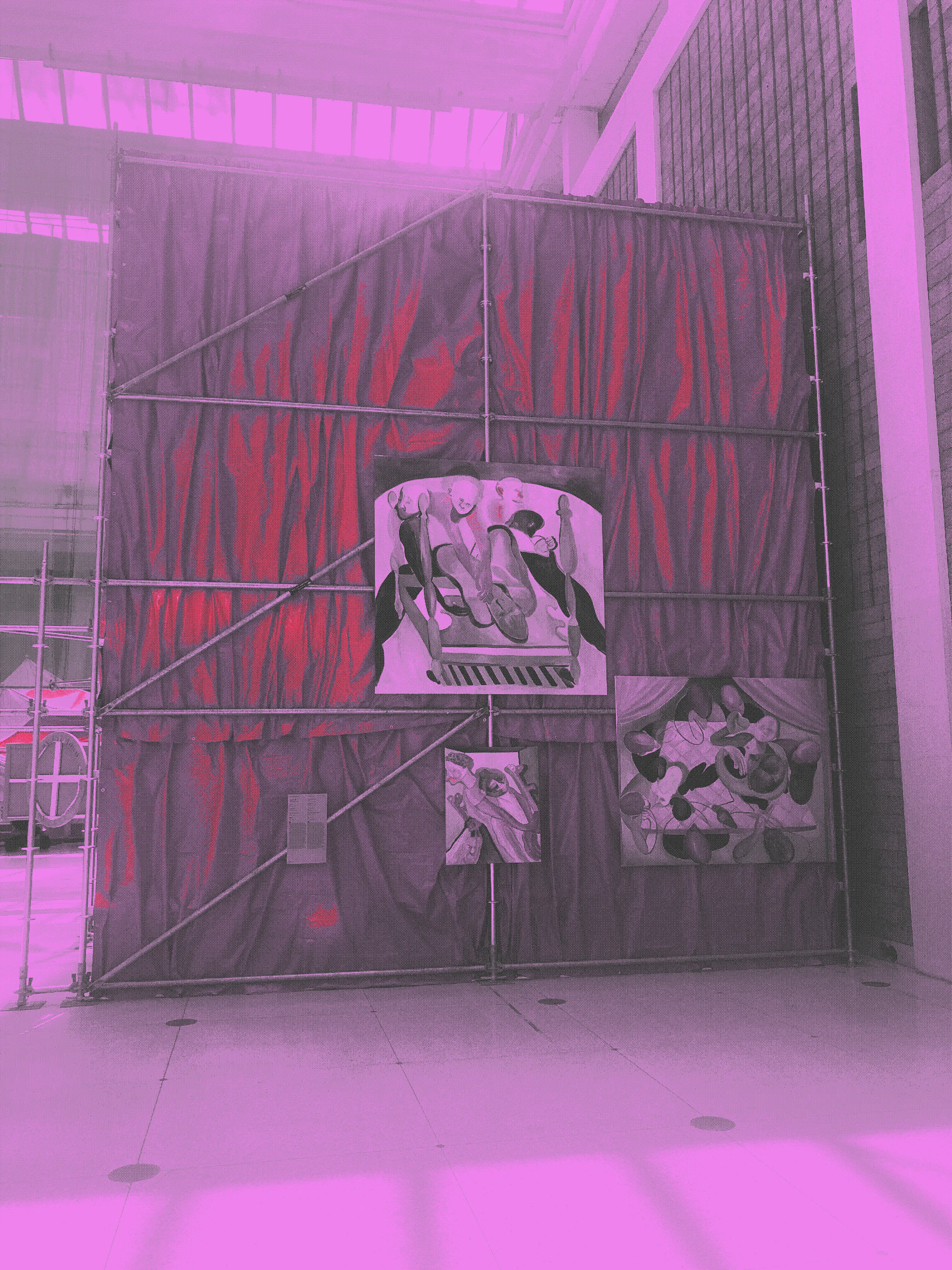 Paintings erected on stretched red fabric on a metal structure